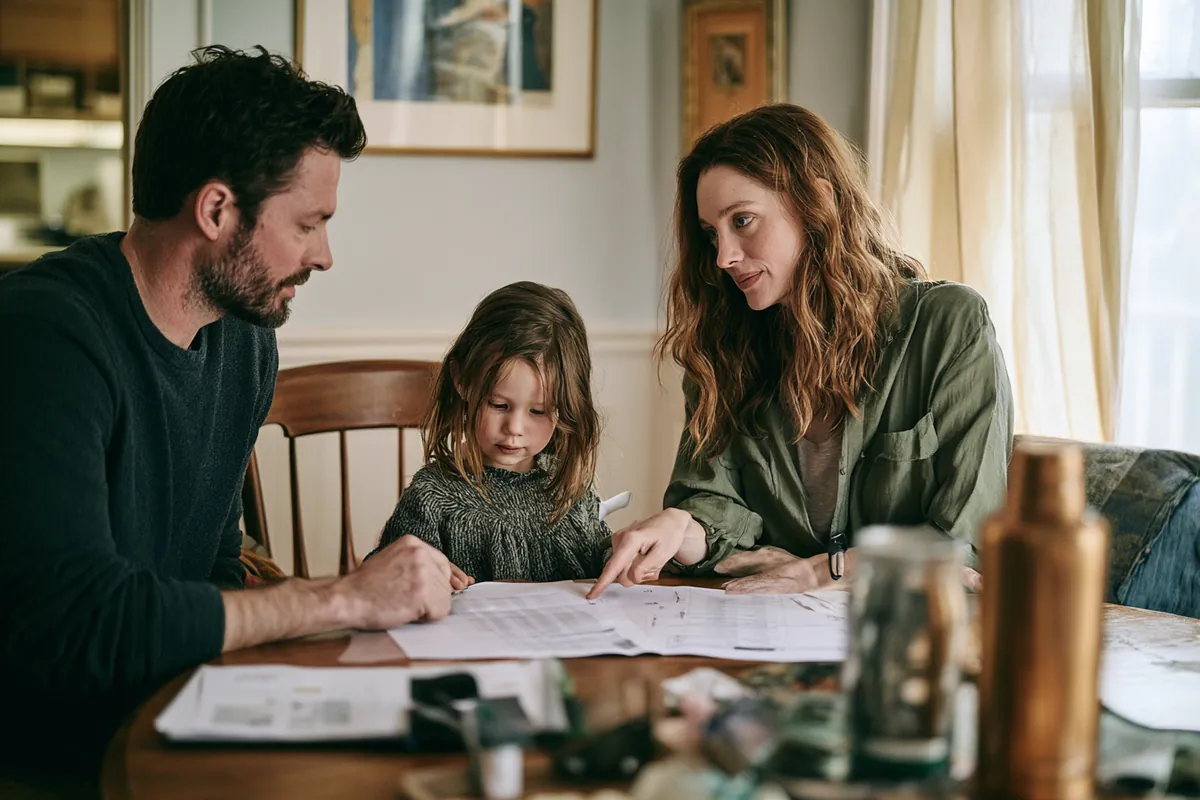 Family reviewing a household budget plan together at their dining table